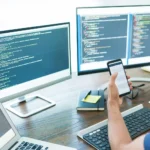 mobile-app-developer-looking-at-multiple-screens
