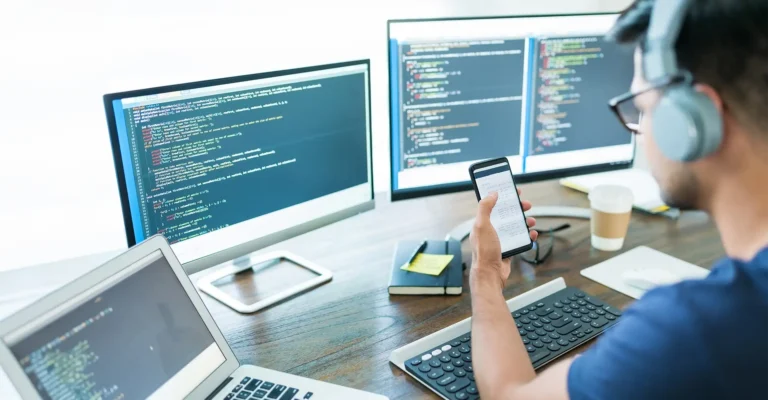 mobile-app-developer-looking-at-multiple-screens
