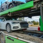 car-carrier-transports-new-cars-trailer-transporting-cars-is-gas-station-concept-road-transportation-services-purchase-sale-used-vehicles-car-delivery_678914-9449